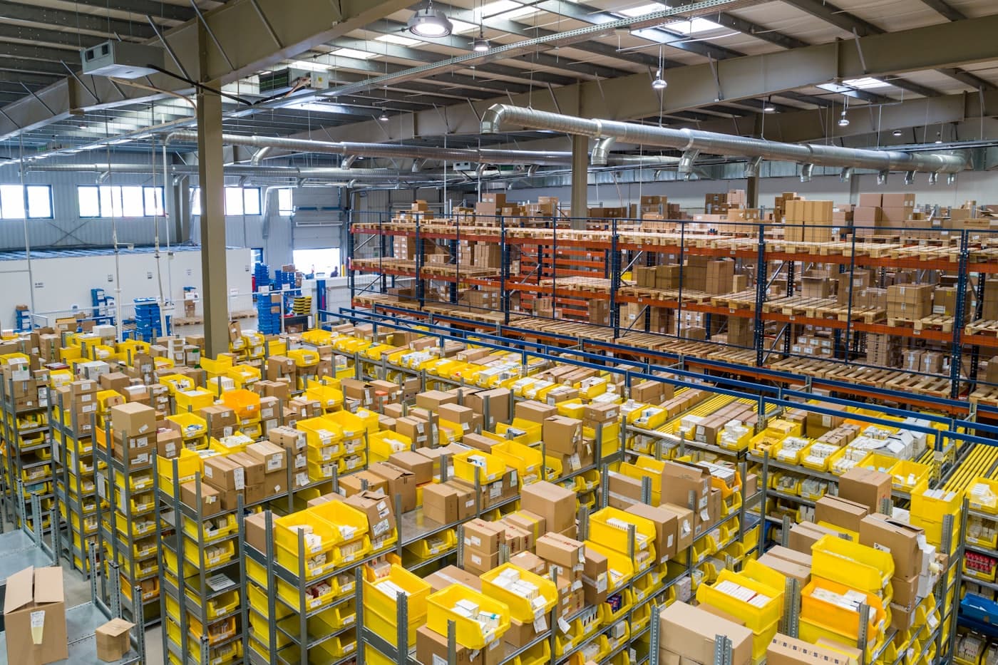 Fulfilment warehouse aisle stacked with shelves of boxed inventory