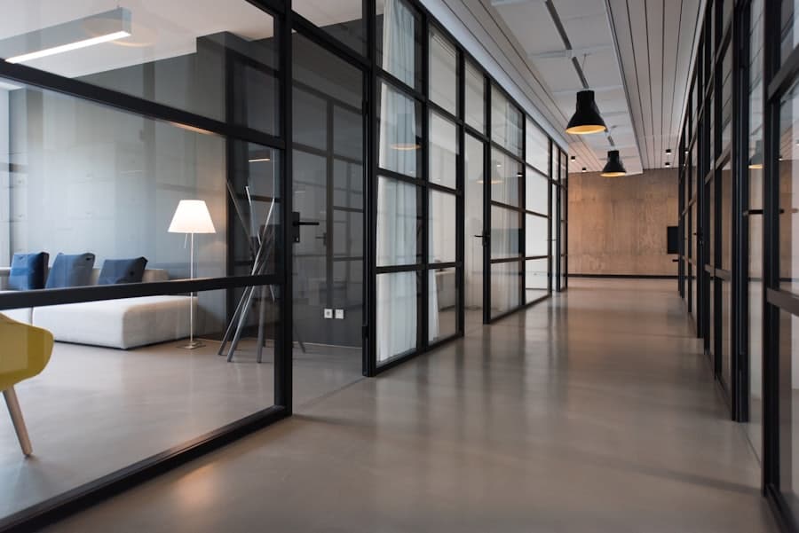 Modern corporate office corridor with glass-walled meeting rooms