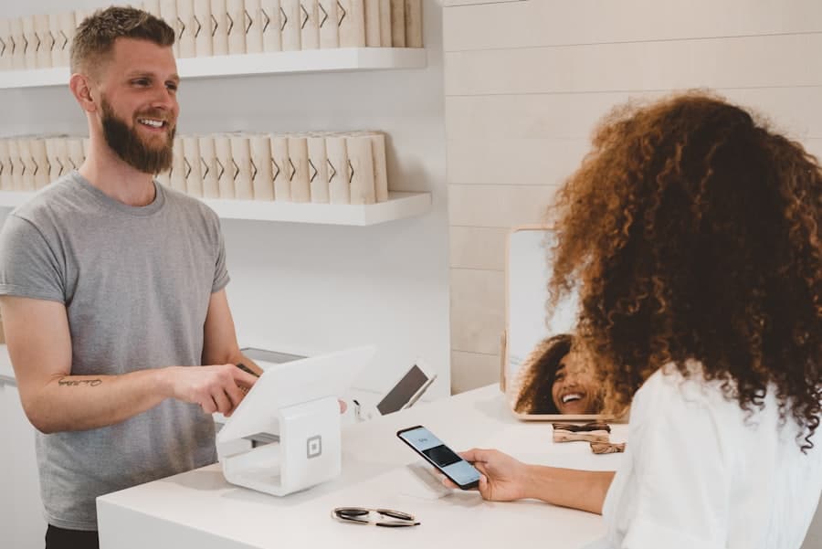 Independent shop owner serving a customer at a boutique checkout counter